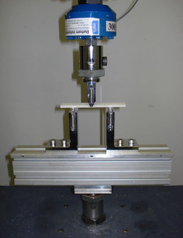 ASTM D790 flexural property test fixture setup.